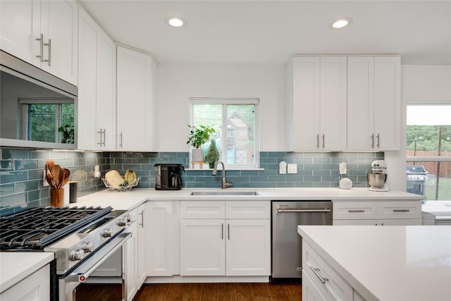 5205 Gladstone Dr, Austin, TX 78723 - kitchen featuring stainless steel appliances, a sink, recessed lighting, light countertops, and dark wood-style flooring