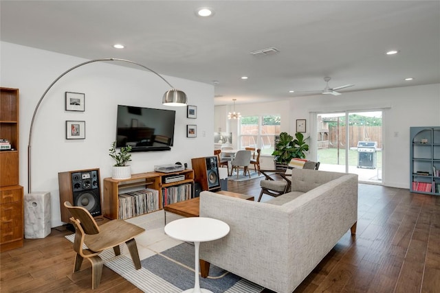 5205 Gladstone Dr, Austin, TX 78723 - living area with dark wood-type flooring, recessed lighting, ceiling fan, and a chandelier