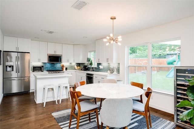 5205 Gladstone Dr, Austin, TX 78723 - dining room with wine cooler, a chandelier, and dark wood-type flooring