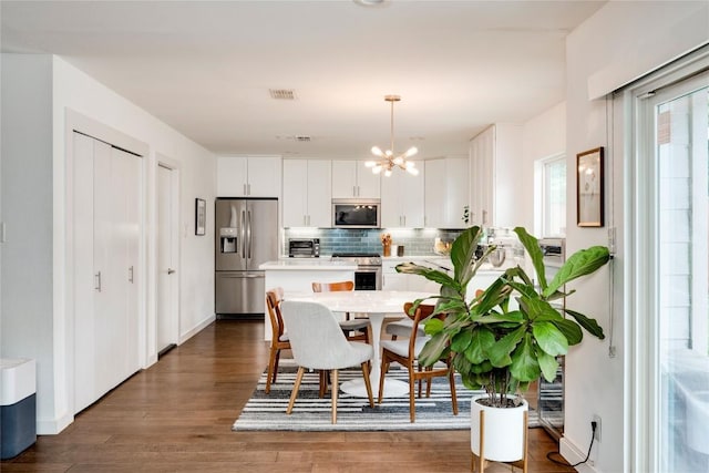 5205 Gladstone Dr, Austin, TX 78723 - dining area with a chandelier and dark wood-style flooring