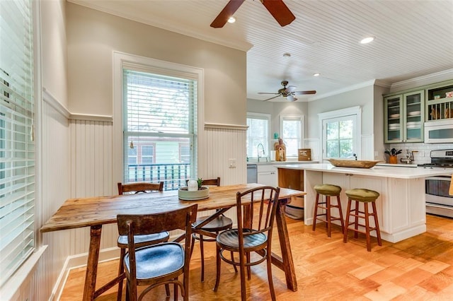 2113 Brooklyn St, Austin, TX 78704 - dining area with ceiling fan, ornamental molding, light wood-style flooring, wainscoting, and recessed lighting