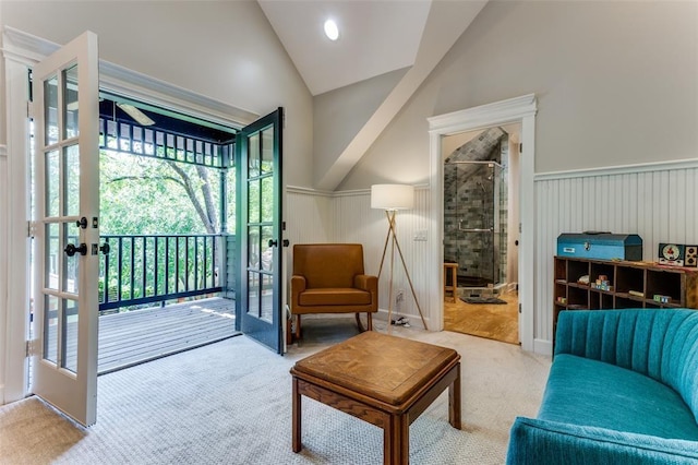 2113 Brooklyn St, Austin, TX 78704 - living room featuring a wainscoted wall, lofted ceiling, carpet, and french doors