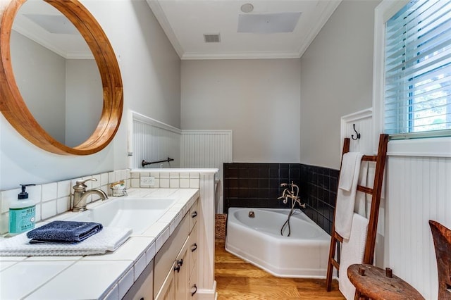 2113 Brooklyn St, Austin, TX 78704 - full bath with vanity, a garden tub, wood finished floors, a wainscoted wall, and ornamental molding