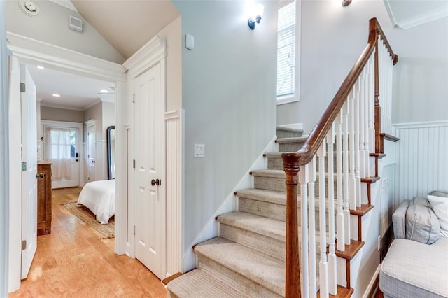 2113 Brooklyn St, Austin, TX 78704 - staircase with crown molding, wood finished floors, and vaulted ceiling
