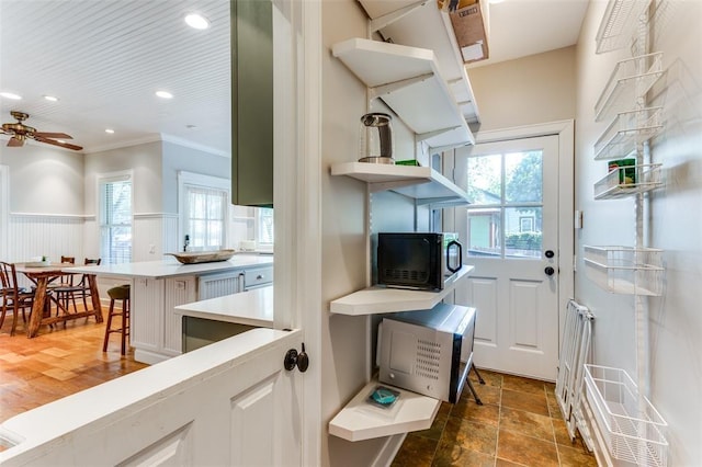2113 Brooklyn St, Austin, TX 78704 - kitchen with black microwave, ornamental molding, light countertops, a ceiling fan, and open shelves