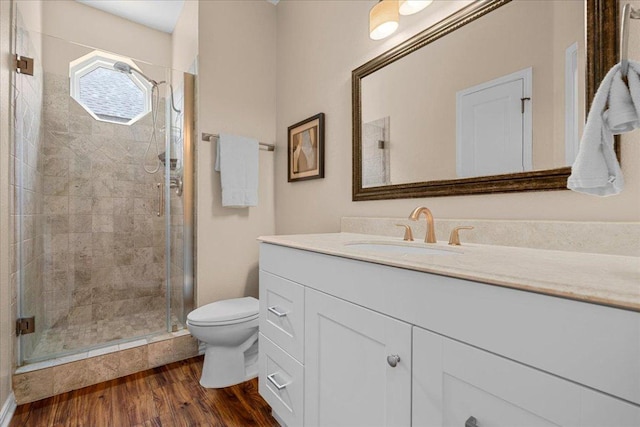 509 Oak Park Dr, Round Rock, TX 78681 - full bathroom with toilet, vanity, a stall shower, and wood finished floors