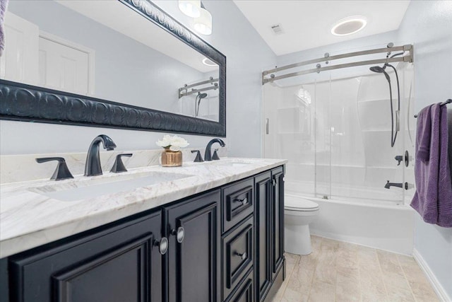 509 Oak Park Dr, Round Rock, TX 78681 - full bathroom with toilet, shower / bath combination with glass door, and double vanity