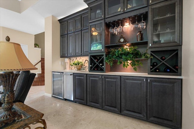 509 Oak Park Dr, Round Rock, TX 78681 - indoor wet bar featuring beverage cooler, tasteful backsplash, and light tile patterned floors