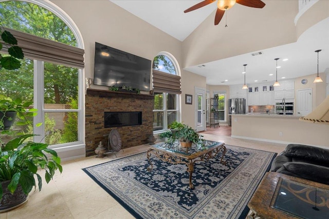 509 Oak Park Dr, Round Rock, TX 78681 - living area with a ceiling fan, a fireplace, and high vaulted ceiling