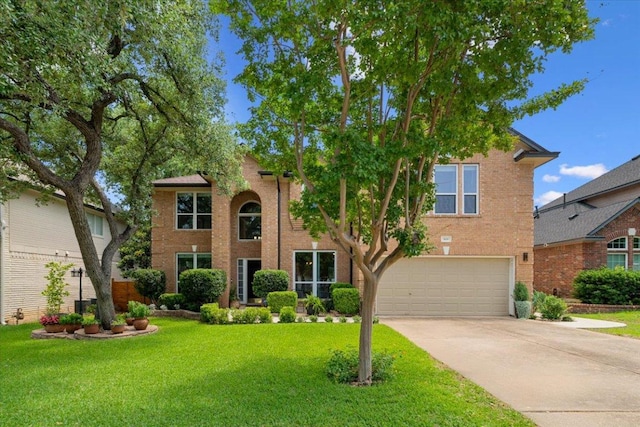 509 Oak Park Dr, Round Rock, TX 78681 - view of front of property with a garage, concrete driveway, a front lawn, and brick siding