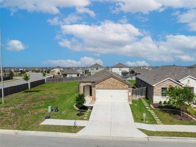 1003 Ascari Ct, Hutto, TX 78634 - view of front of home with a residential view, concrete driveway, brick siding, and a garage