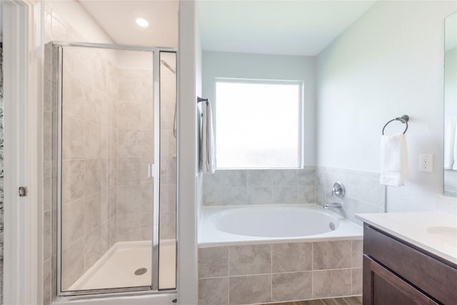 1003 Ascari Ct, Hutto, TX 78634 - bathroom featuring vanity, a garden tub, and a shower stall