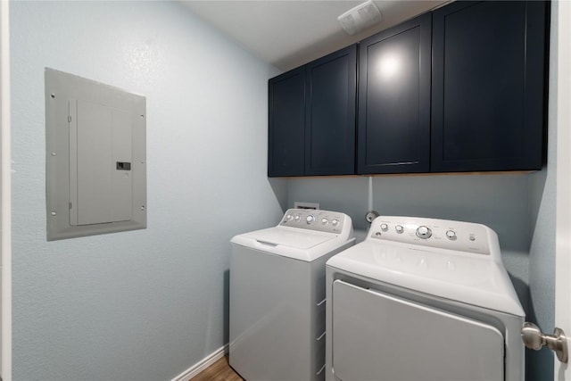 1003 Ascari Ct, Hutto, TX 78634 - washroom with electric panel, cabinet space, washing machine and dryer, and baseboards