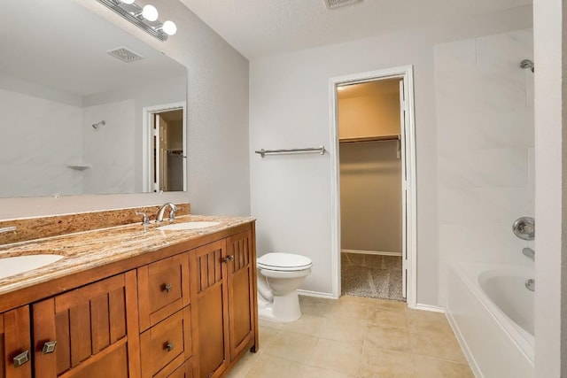 9001 China Rose Dr, Austin, TX 78724 - full bath featuring toilet, double vanity, a walk in closet, shower / bathtub combination, and tile patterned flooring