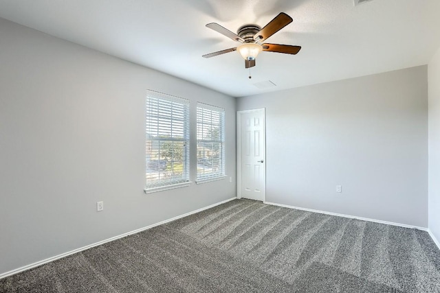 9001 China Rose Dr, Austin, TX 78724 - spare room featuring dark carpet, a ceiling fan, and baseboards