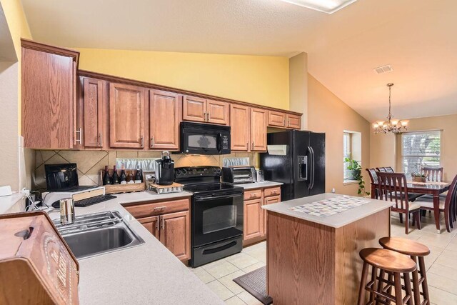 1007 Big Spring Dr, Cedar Park, TX 78613 - kitchen featuring black appliances, light countertops, a chandelier, decorative backsplash, and high vaulted ceiling