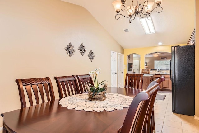 1007 Big Spring Dr, Cedar Park, TX 78613 - dining room featuring lofted ceiling, a chandelier, arched walkways, and light tile patterned floors