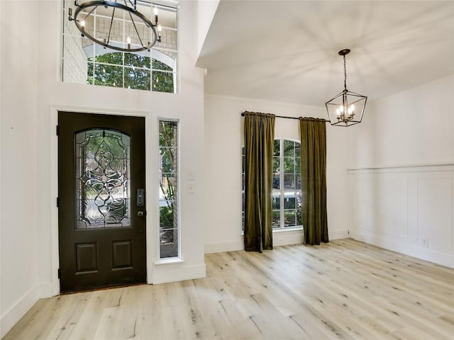 4109 Moss Hollow Dr, Round Rock, TX 78681 - entryway featuring a chandelier, wood finished floors, crown molding, a wainscoted wall, and baseboards