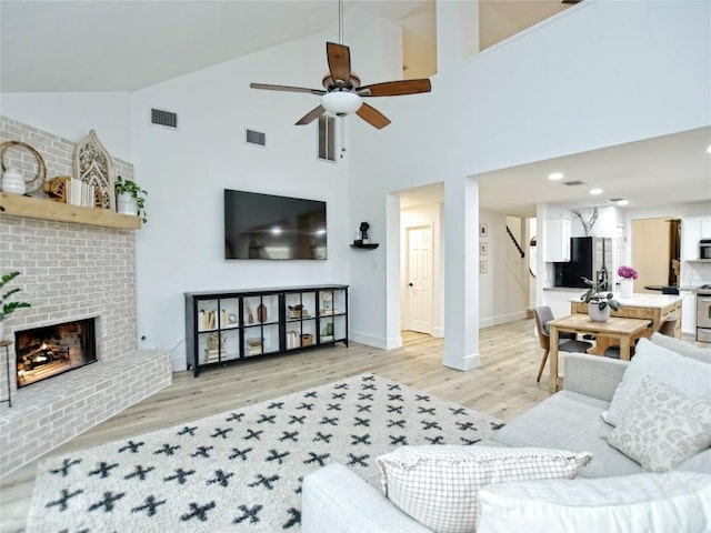 4109 Moss Hollow Dr, Round Rock, TX 78681 - living room featuring light wood-style floors, high vaulted ceiling, ceiling fan, baseboards, and stairway