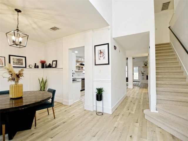 4109 Moss Hollow Dr, Round Rock, TX 78681 - hallway featuring light wood finished floors, stairs, a chandelier, and baseboards