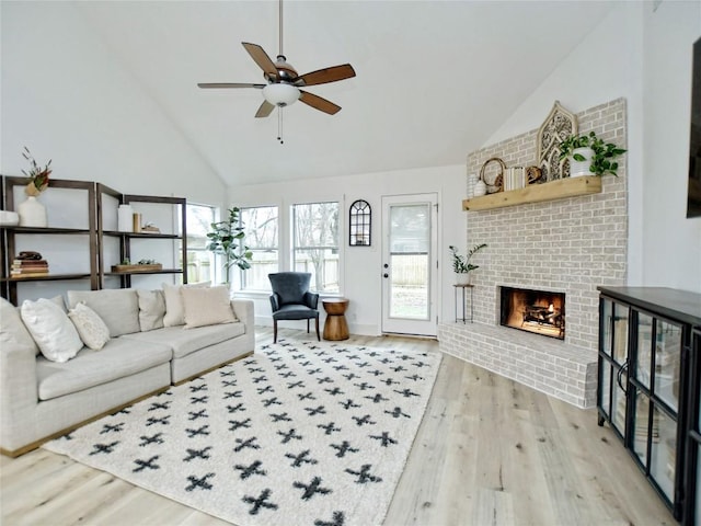 4109 Moss Hollow Dr, Round Rock, TX 78681 - living room featuring light wood finished floors, a fireplace, ceiling fan, and high vaulted ceiling