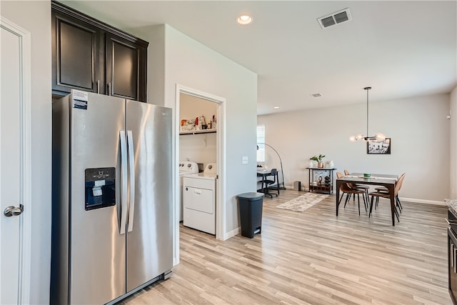 10317 Laurie Ln, Austin, TX 78747 - kitchen with stainless steel fridge with ice dispenser, washer and clothes dryer, light wood-type flooring, recessed lighting, and decorative light fixtures