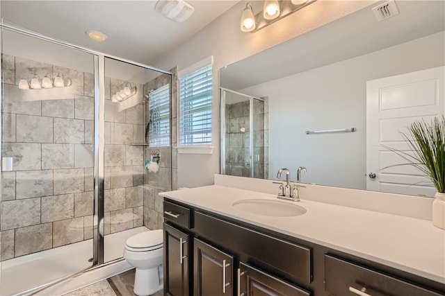 10317 Laurie Ln, Austin, TX 78747 - bathroom with vanity, toilet, and a stall shower