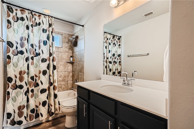 10317 Laurie Ln, Austin, TX 78747 - full bath with toilet, vanity, shower / bath combo, and wood finished floors
