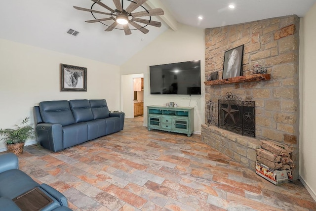 20217 Engelmann Ln, Manor, TX 78653 - living area with a ceiling fan, beamed ceiling, stone finish flooring, a stone fireplace, and high vaulted ceiling