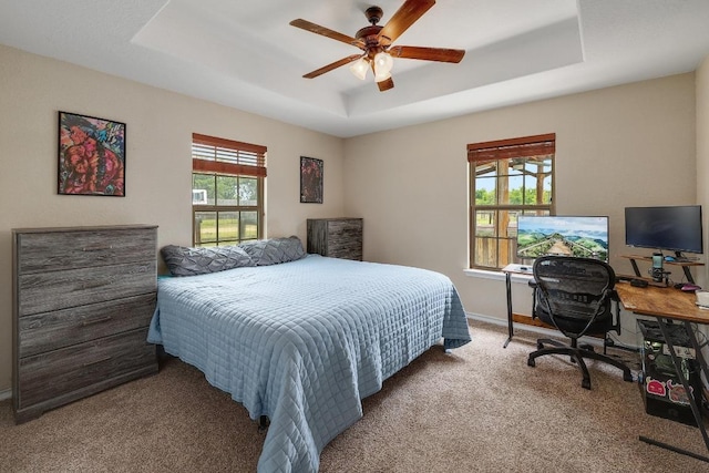 20217 Engelmann Ln, Manor, TX 78653 - bedroom with a raised ceiling, carpet flooring, baseboards, a desk, and a ceiling fan