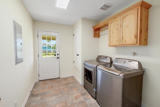 20217 Engelmann Ln, Manor, TX 78653 - washroom featuring washer and dryer, cabinet space, baseboards, electric panel, and stone tile floors