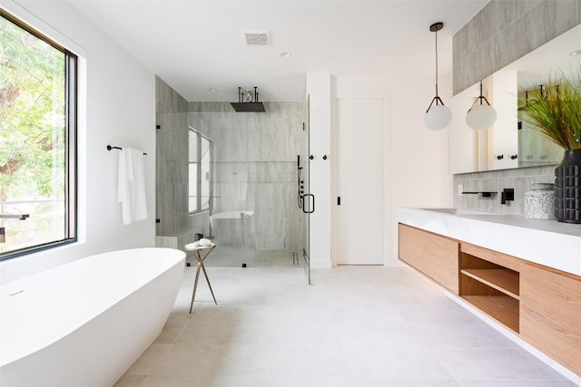 2807 Garwood St, Austin, TX 78702 - bathroom with a stall shower, a soaking tub, and vanity