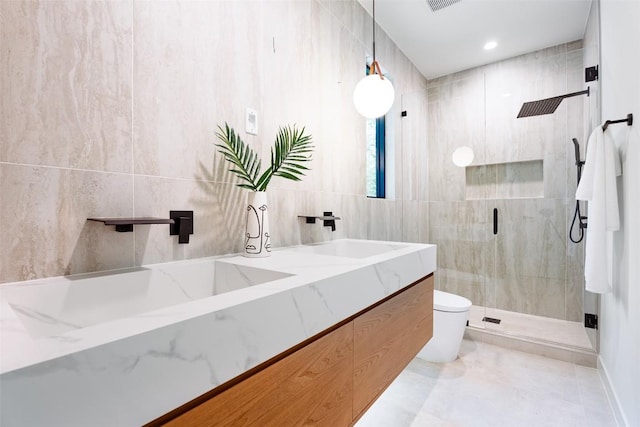 2807 Garwood St, Austin, TX 78702 - full bathroom with tile walls, a stall shower, toilet, and double vanity