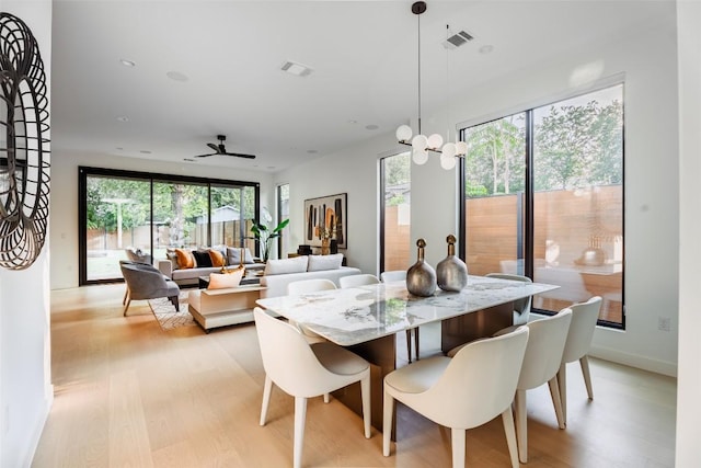 2807 Garwood St, Austin, TX 78702 - dining room featuring light wood-style floors, ceiling fan, and baseboards