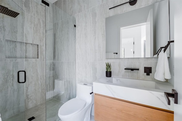 2807 Garwood St, Austin, TX 78702 - bathroom with a shower stall, tile walls, vanity, and toilet