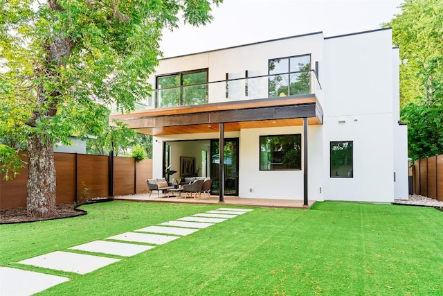 2807 Garwood St, Austin, TX 78702 - back of property with a balcony, a patio area, and stucco siding