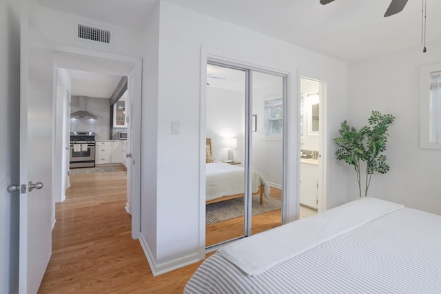 3303 S Oak Dr, Austin, TX 78704 - bedroom with light wood finished floors, a closet, a ceiling fan, and baseboards