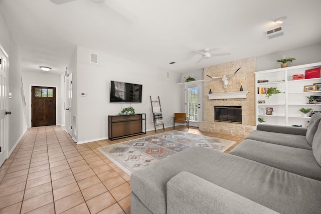 10805 Flashpoint Ct, Austin, TX 78736 - living area with ceiling fan, healthy amount of natural light, light tile patterned floors, and a stone fireplace