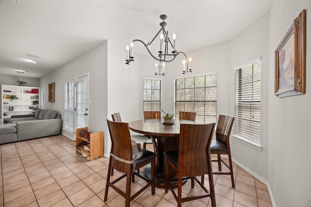 10805 Flashpoint Ct, Austin, TX 78736 - dining room with light tile patterned floors, a chandelier, and baseboards