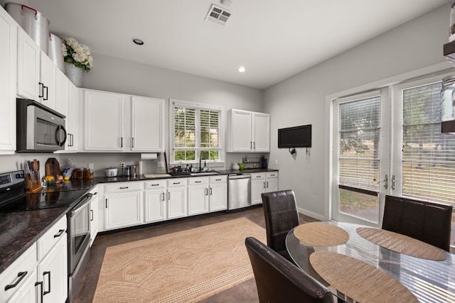 10805 Flashpoint Ct, Austin, TX 78736 - kitchen with appliances with stainless steel finishes, dark countertops, white cabinetry, recessed lighting, and baseboards