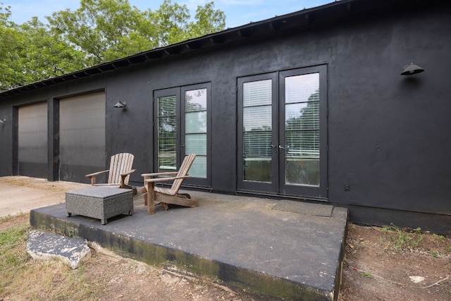 10805 Flashpoint Ct, Austin, TX 78736 - rear view of property featuring stucco siding, a patio, and french doors