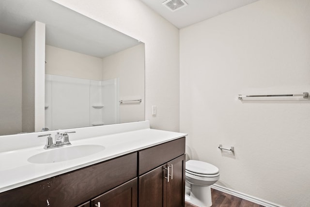 128 Rock Nettle, New Braunfels, TX 78130 - full bathroom featuring wood finished floors, toilet, vanity, baseboards, and a shower