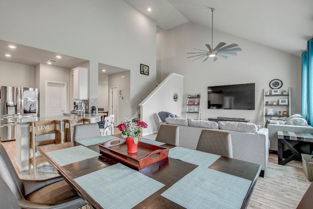 17101 Borromeo Ave, Pflugerville, TX 78660 - dining space with high vaulted ceiling, a ceiling fan, stairs, light wood-type flooring, and recessed lighting