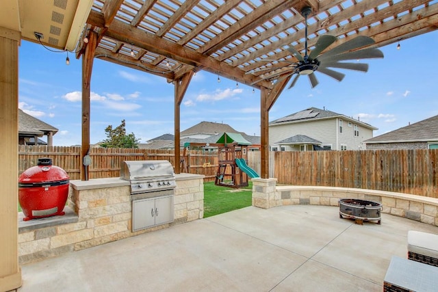 17101 Borromeo Ave, Pflugerville, TX 78660 - fenced backyard featuring an outdoor fire pit, a patio, a ceiling fan, a playground, and a pergola