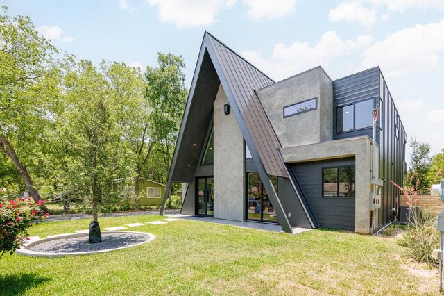 4506 Clawson Rd Unit 1, Austin, TX 78745 - rear view of house featuring a yard, central AC unit, a standing seam roof, and metal roof