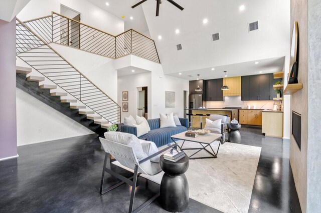 4506 Clawson Rd Unit 1, Austin, TX 78745 - living area featuring a towering ceiling, stairway, recessed lighting, and a fireplace