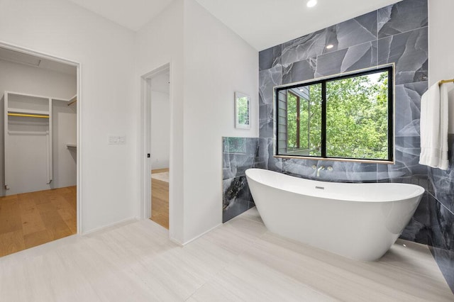 4506 Clawson Rd Unit 1, Austin, TX 78745 - full bathroom with tile walls, a soaking tub, and a walk in closet