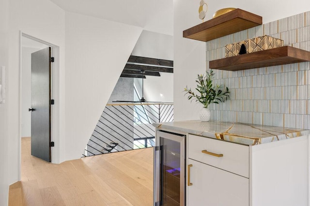4506 Clawson Rd Unit 1, Austin, TX 78745 - kitchen with beverage cooler, open shelves, white cabinetry, decorative backsplash, and light wood-type flooring