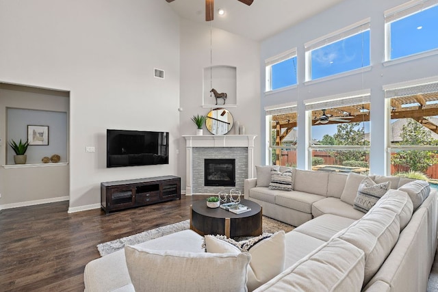2313 Legend Hill Dr, Leander, TX 78641 - living room with ceiling fan, a high ceiling, wood finished floors, a fireplace, and recessed lighting