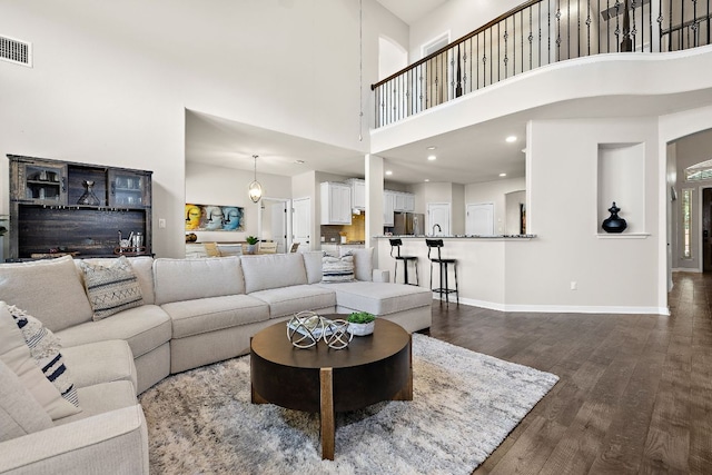 2313 Legend Hill Dr, Leander, TX 78641 - living area with a towering ceiling and dark wood-style flooring